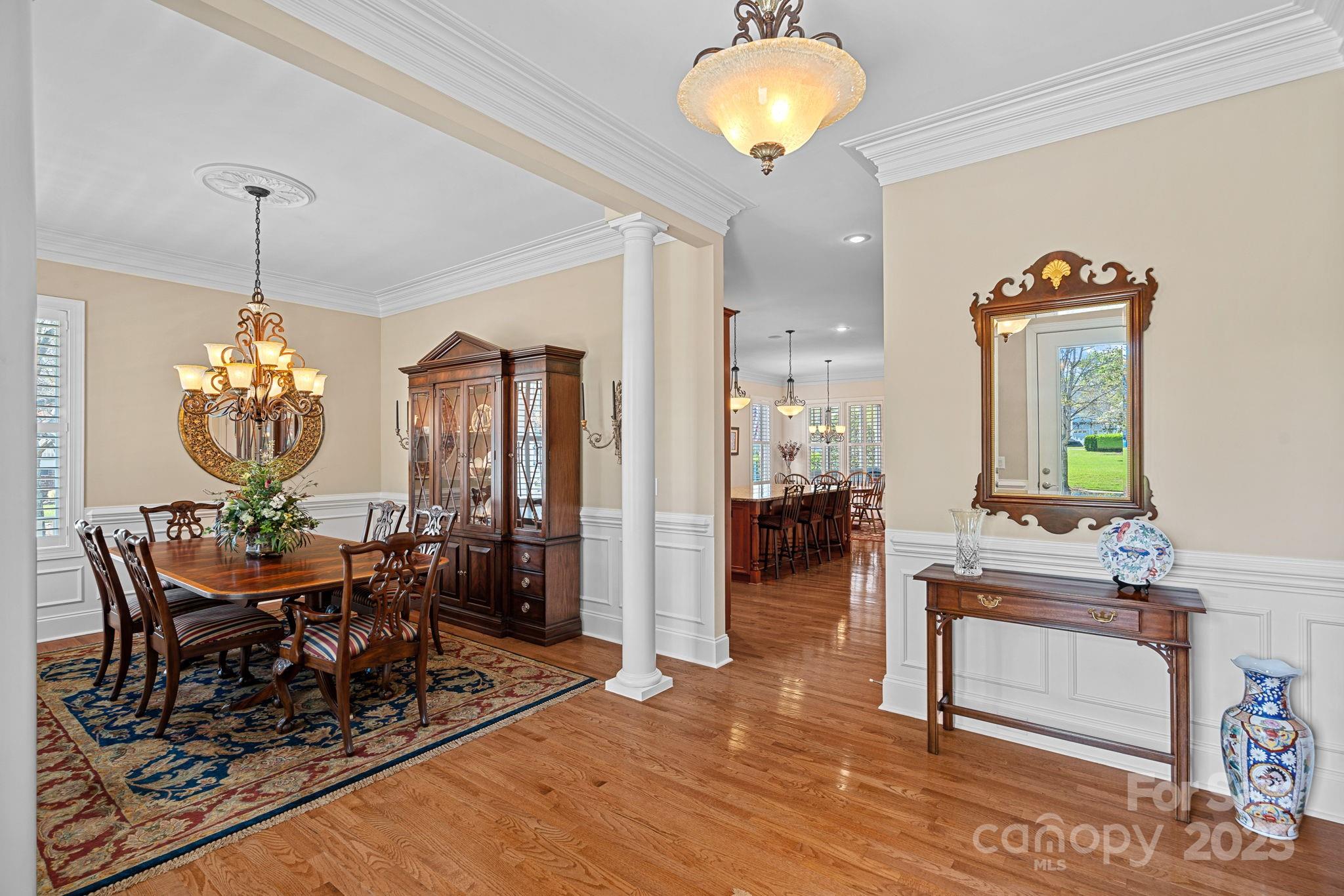 9803 Tree Canopy Road Charlotte, NC 28277 - Photo 2 of 42 a view of a dining room and livingroom with furniture wooden floor a chandelier