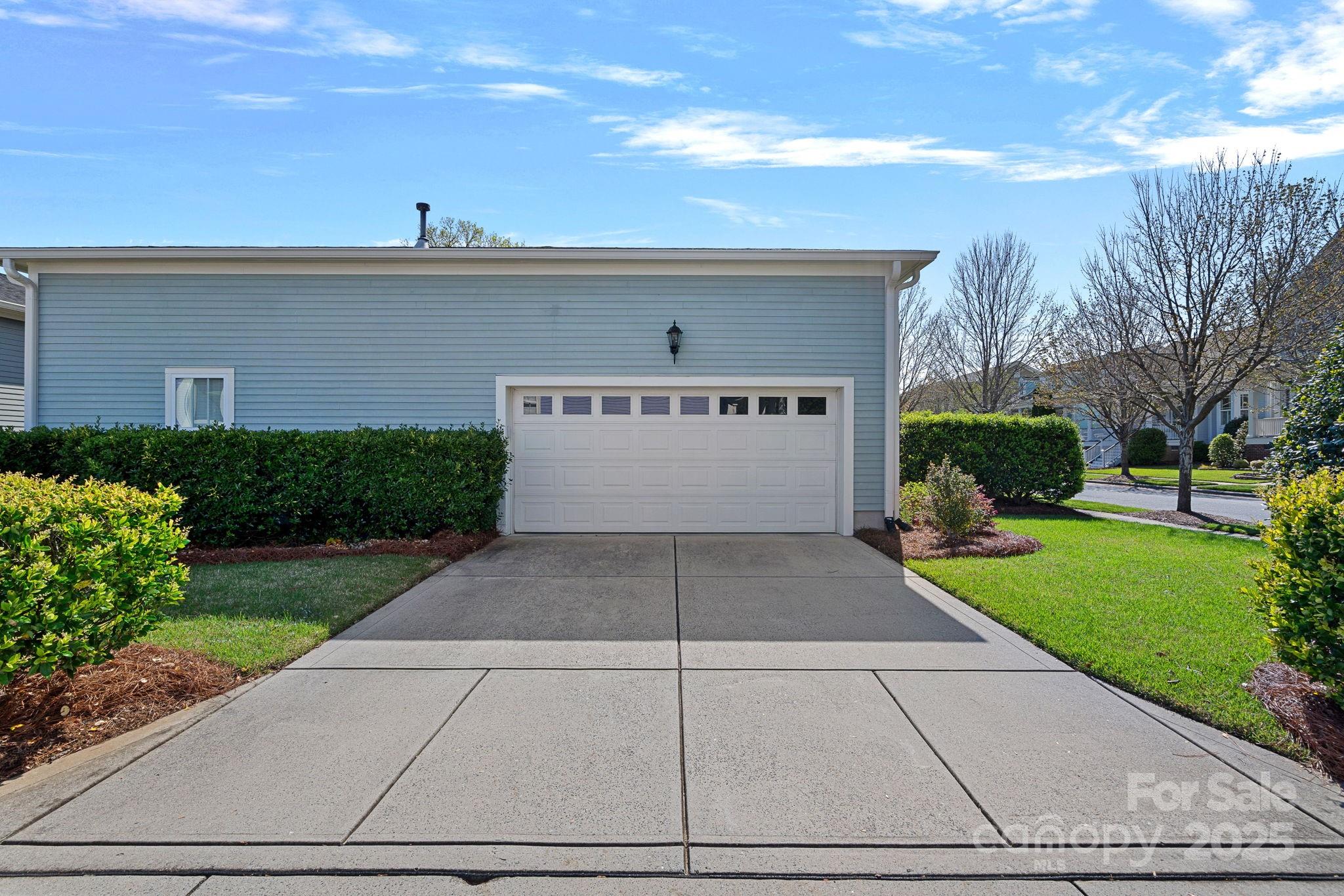 9803 Tree Canopy Road Charlotte, NC 28277 - Photo 32 of 42 a front view of a house with a yard and a garage