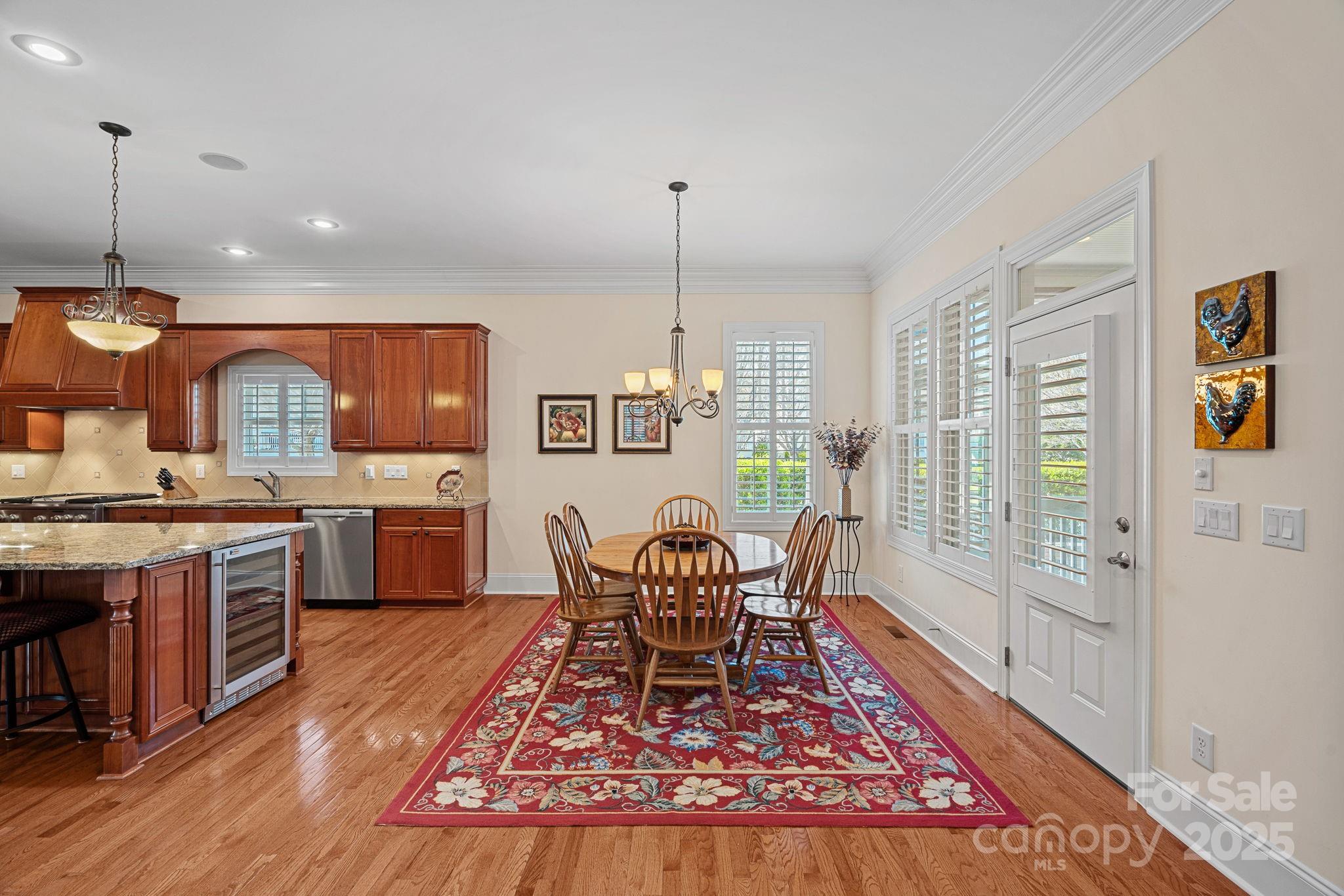 9803 Tree Canopy Road Charlotte, NC 28277 - Photo 8 of 42 a living room with stainless steel appliances granite countertop furniture wooden floor and a rug