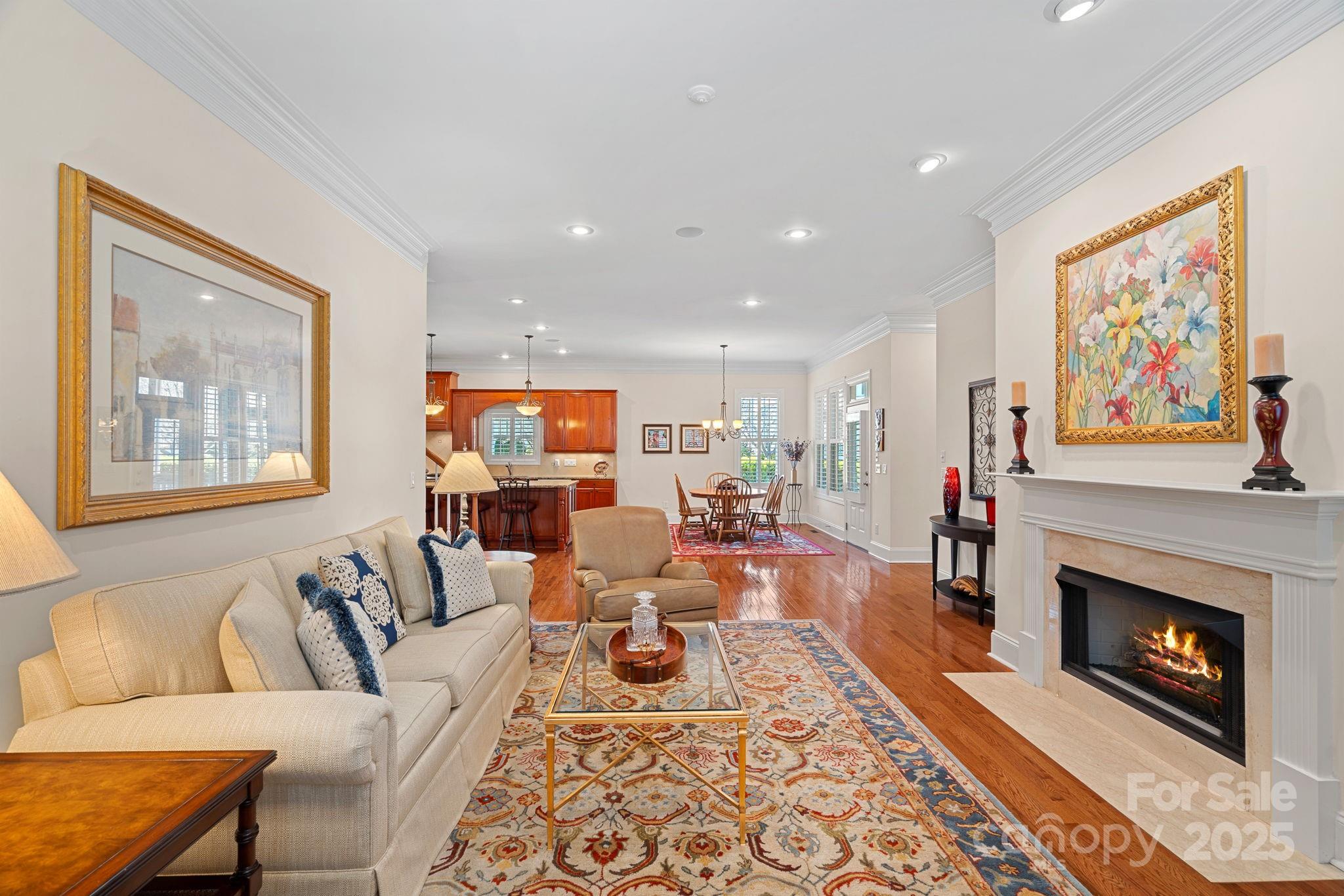 9803 Tree Canopy Road Charlotte, NC 28277 - Photo 10 of 42 a living room with furniture a fireplace and a painting on the wall