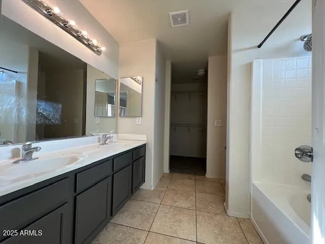 a spacious bathroom with a bathtub sink and mirror