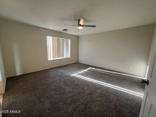 19289 North Leland Road Maricopa, AZ 85138 - Photo 3 of 11 an empty room with windows and ceiling fan