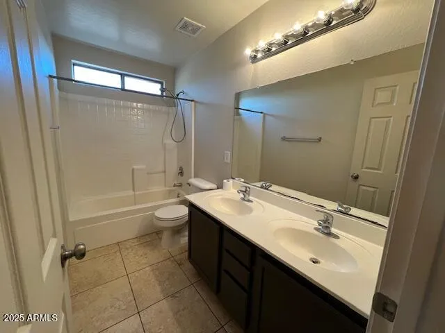 a bathroom with a double vanity sink toilet mirror and shower