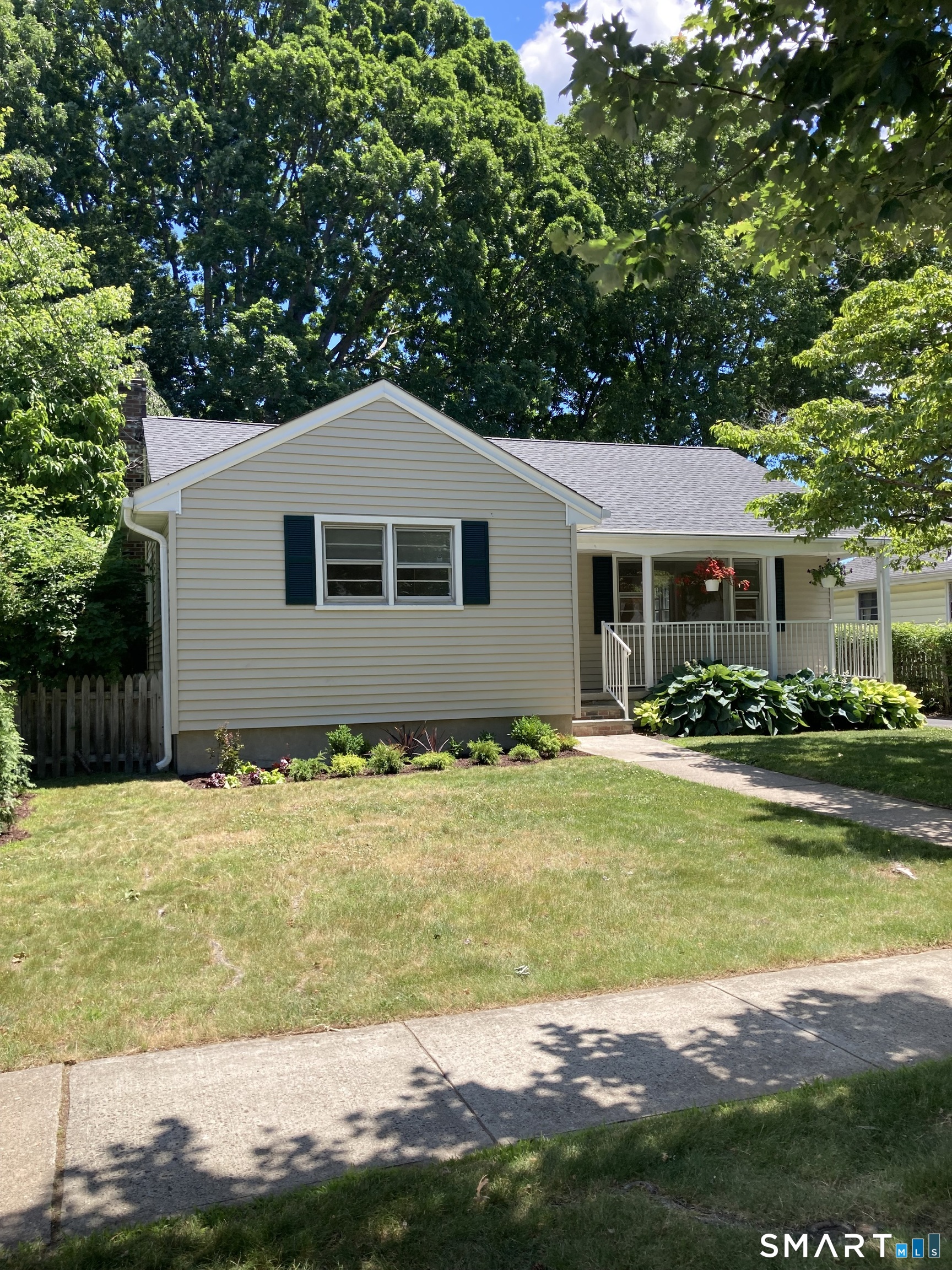 140 Spring Street Stratford, CT 06614 - Photo 1 of 29 a front view of a house with a yard
