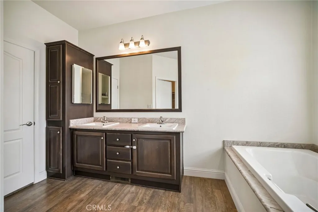250 East Telegraph Road, Unit 307 Fillmore, CA 93015 - Photo 26 of 36 a bathroom with a tub sink and mirror