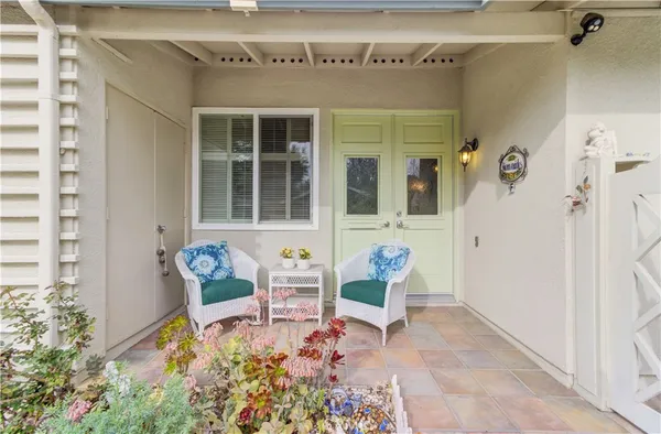 a front view of a house with a yard and a garden