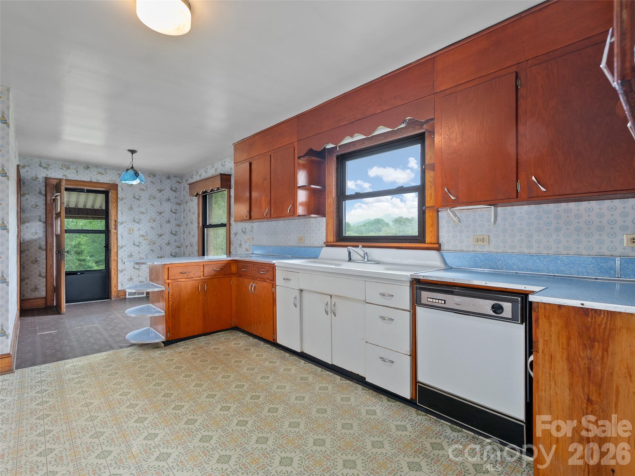 21 Beaverdam Road Canton, NC 28716 - Photo 12 of 24 a kitchen with granite countertop a sink cabinets and window
