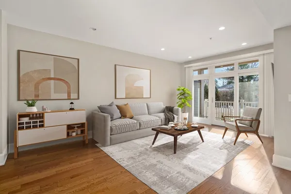 a living room with furniture and a potted plant
