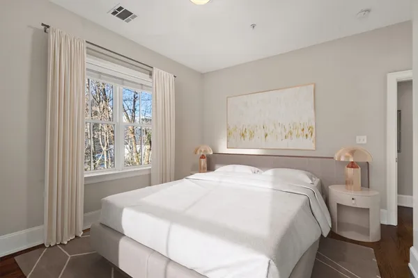 a bedroom with a large bed and a window