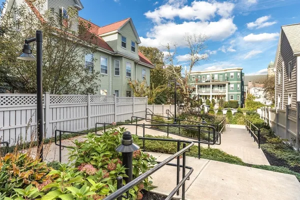 a view of a patio with couches table and chairs and potted plants