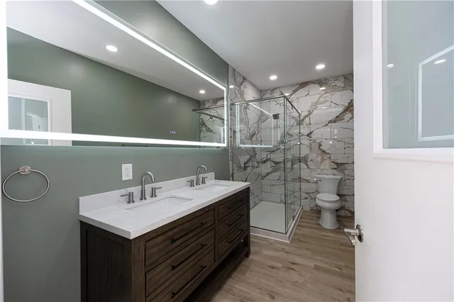 a kitchen with a refrigerator cabinets and wooden floor
