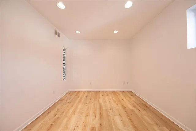 a view of room with wooden floor and fan