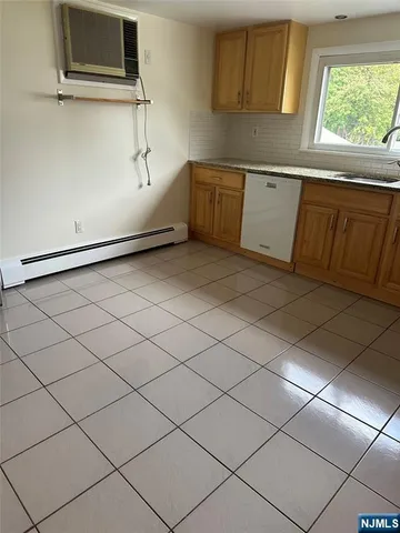 a kitchen with a refrigerator and window