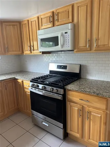 a stove top oven sitting inside of a kitchen