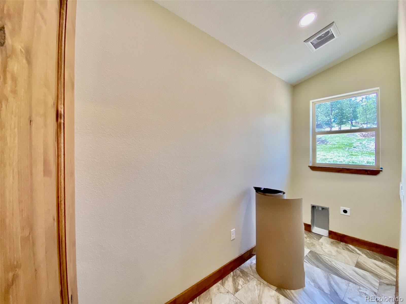 174 Chickadee Lane Bailey, CO 80421 - Photo 13 of 39 a view of a hallway with wooden floor and a cabinet