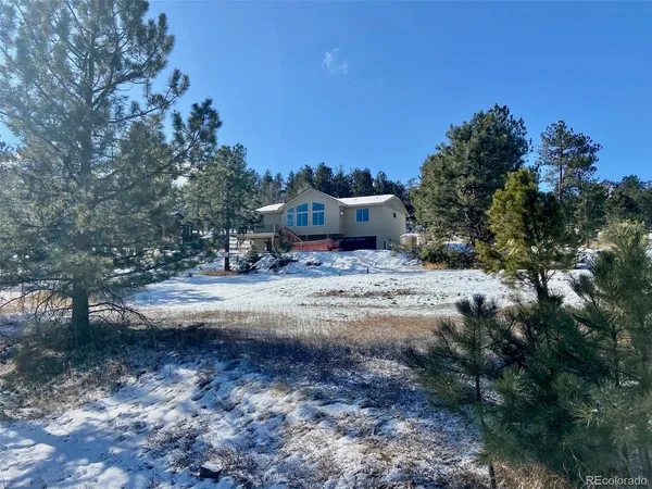 a view of the house with a yard