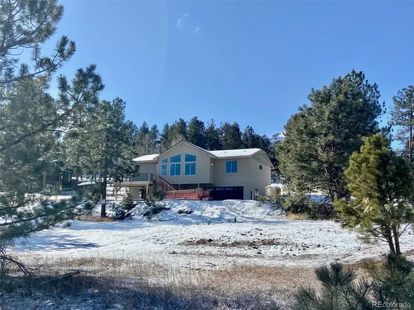 a view of a house with a yard covered in snow