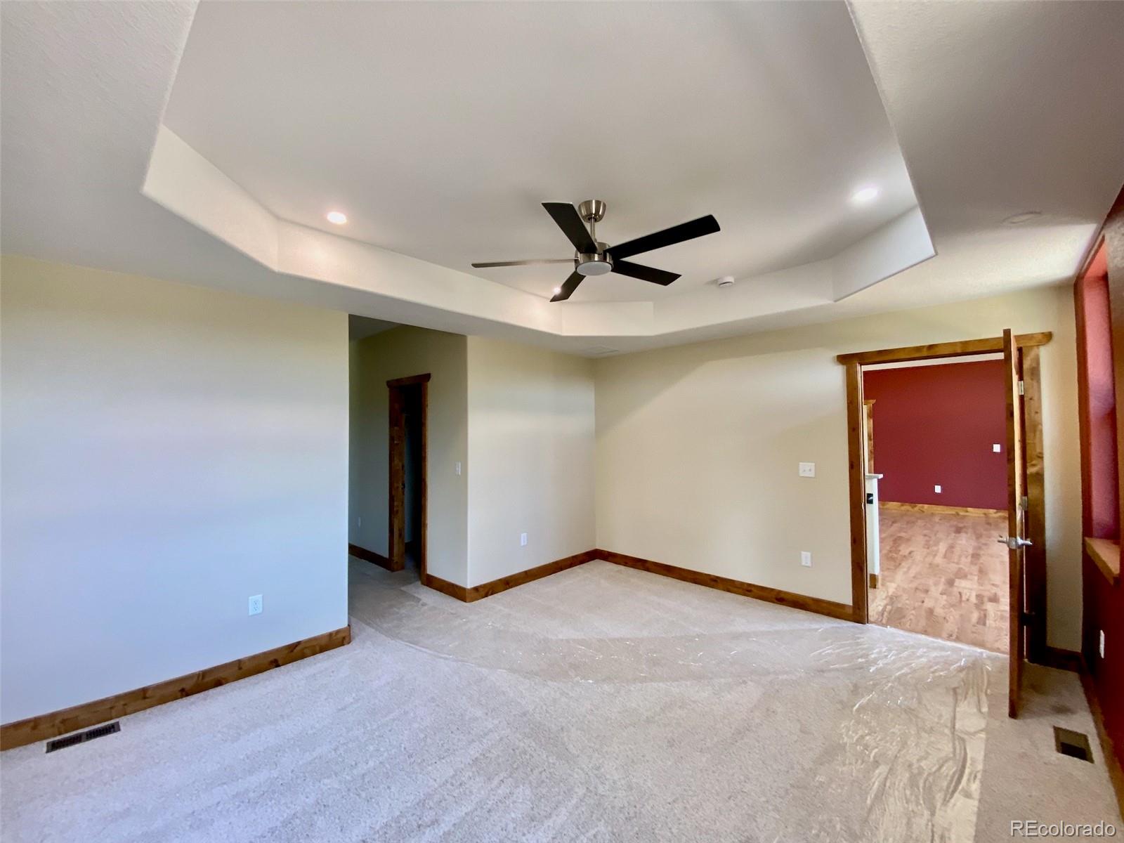 174 Chickadee Lane Bailey, CO 80421 - Photo 8 of 39 a view of a livingroom with a ceiling fan & entryway