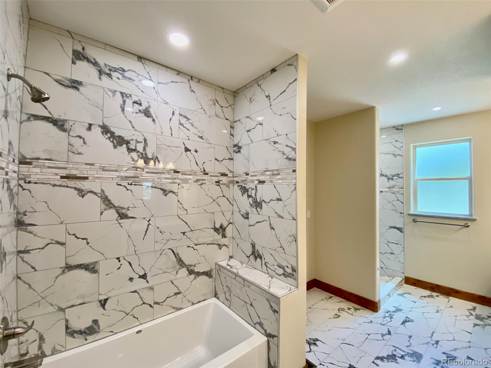 174 Chickadee Lane Bailey, CO 80421 - Photo 10 of 39 a bathroom with a bathtub and shower