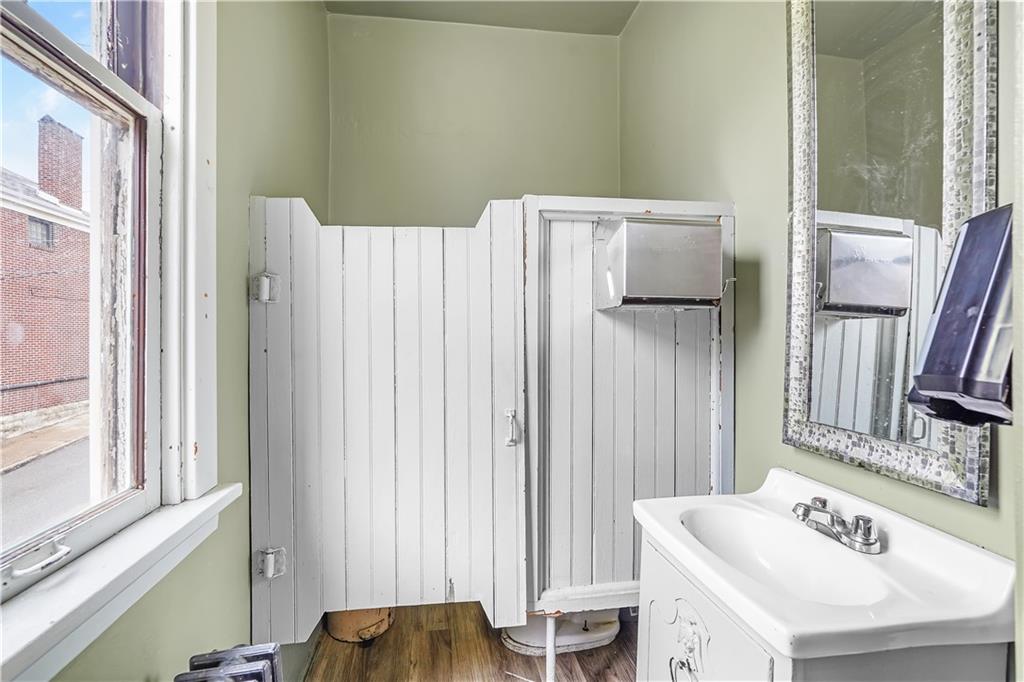 2100 Spring Street Pittsburgh, PA 15210 - Photo 11 of 14 a bathroom with a sink and a mirror