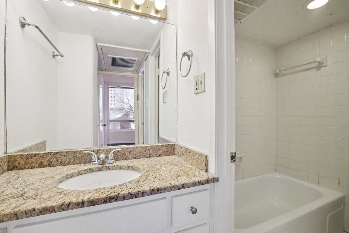 1212 Guadalupe Street, Unit 210 Austin, TX 78701 - Photo 5 of 12 Bathroom with vanity and shower / washtub combination