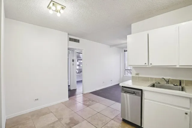 a kitchen with a sink and cabinets