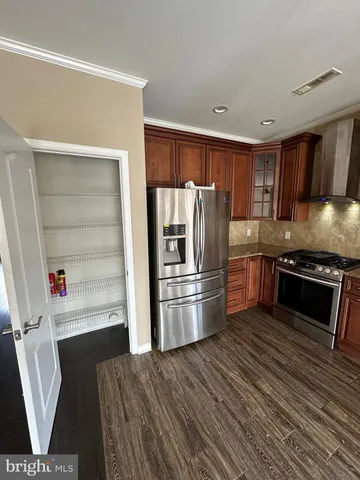 a kitchen with stainless steel appliances a refrigerator sink and microwave