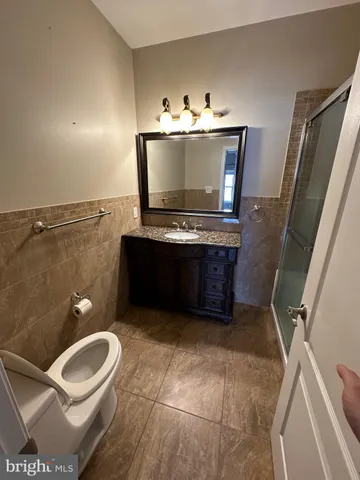 a bathroom with a toilet mirror vanity and toilet