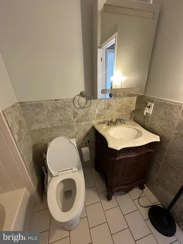 a bathroom with a sink mirror vanity and toilet