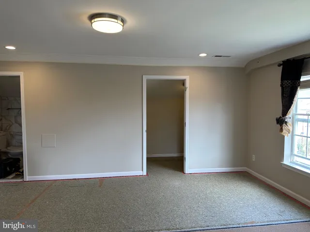 a view of a livingroom with wooden floor and window