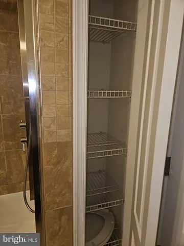 a white toilet sitting next to a bathroom sink