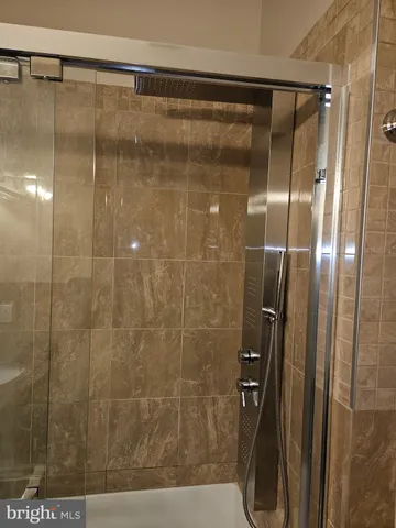 a bathroom with a granite countertop sink a toilet and shower