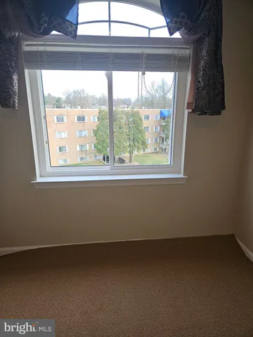 an empty room with wooden floor and closet