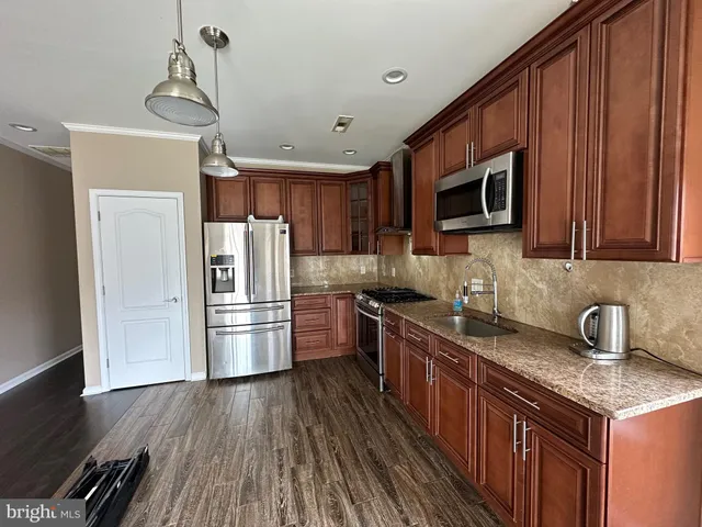 a kitchen with a refrigerator sink and microwave