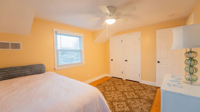 a bedroom with a bed and a window