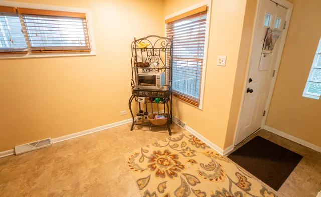 a view of a room with wooden floor and a window