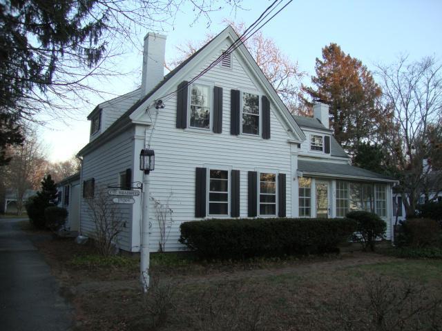 128 Old Stage Road Centerville, MA 02632 - Photo 1 of 17 a front view of a house with a garden