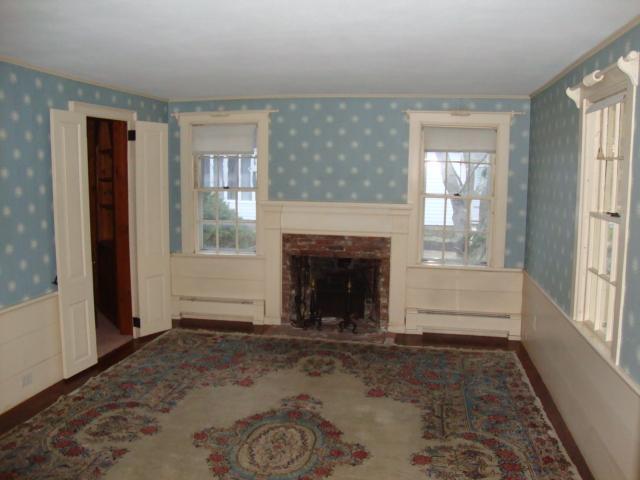 128 Old Stage Road Centerville, MA 02632 - Photo 3 of 17 a view of an empty room with window and fire place