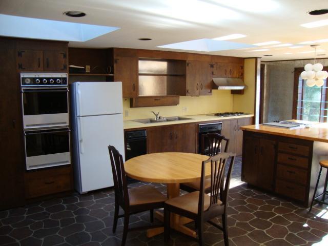 128 Old Stage Road Centerville, MA 02632 - Photo 6 of 17 a kitchen with a dining table chairs and refrigerator