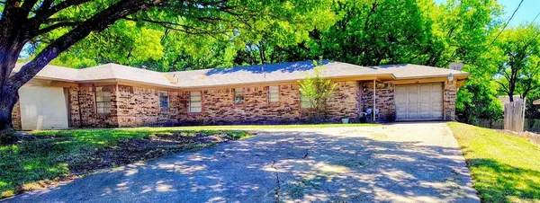 a view of a house with a yard and large trees