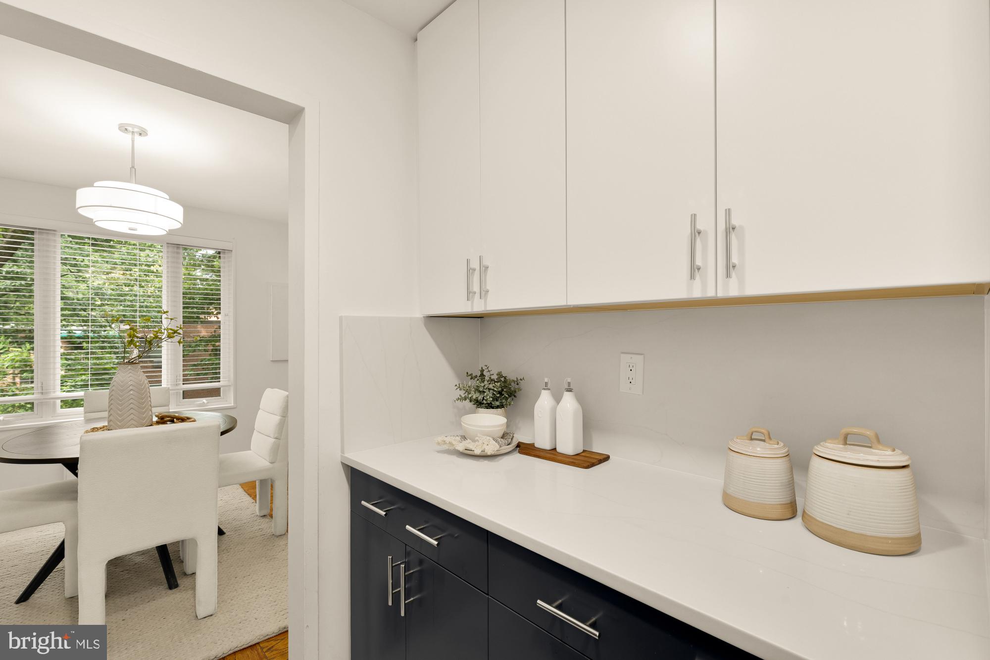 2400 41st Street Northwest, Unit 212 Washington, DC 20007 - Photo 13 of 24 a kitchen with a table and a potted plant