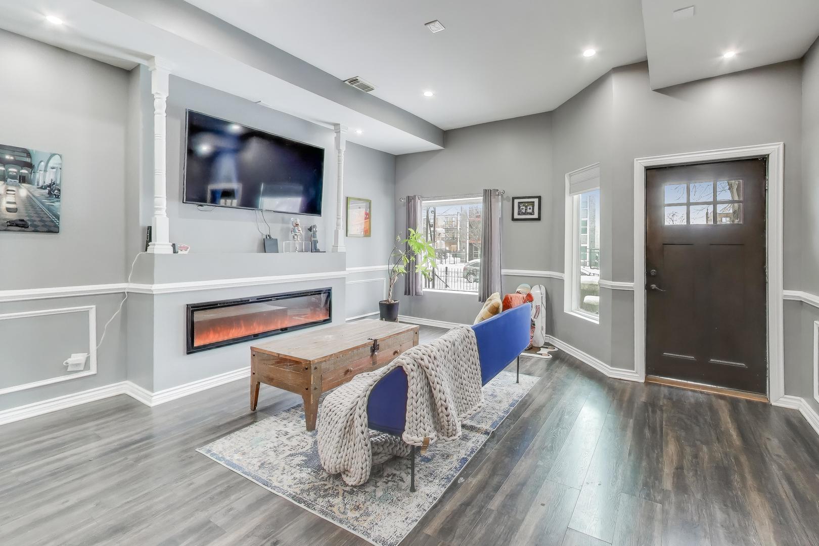 4049 South Indiana Avenue Chicago, IL 60653 - Photo 4 of 23 a living room with furniture a flat screen tv and kitchen view