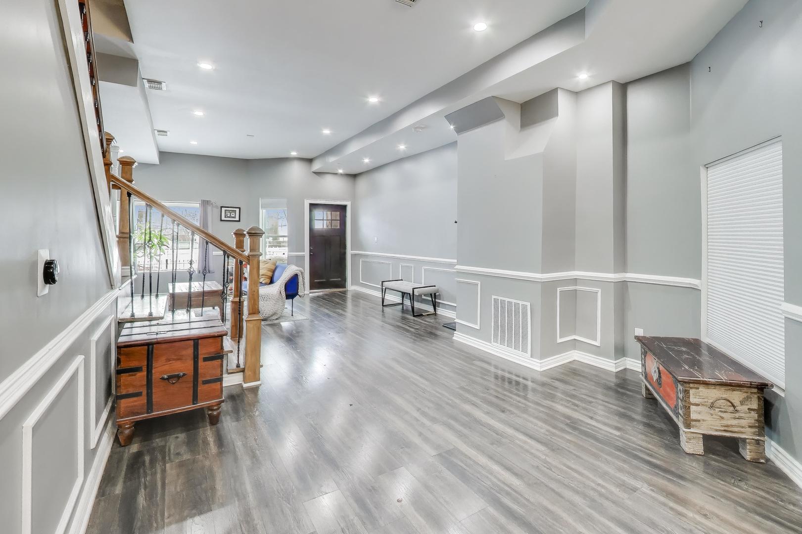 4049 South Indiana Avenue Chicago, IL 60653 - Photo 5 of 23 a hallway with wooden floor and furniture