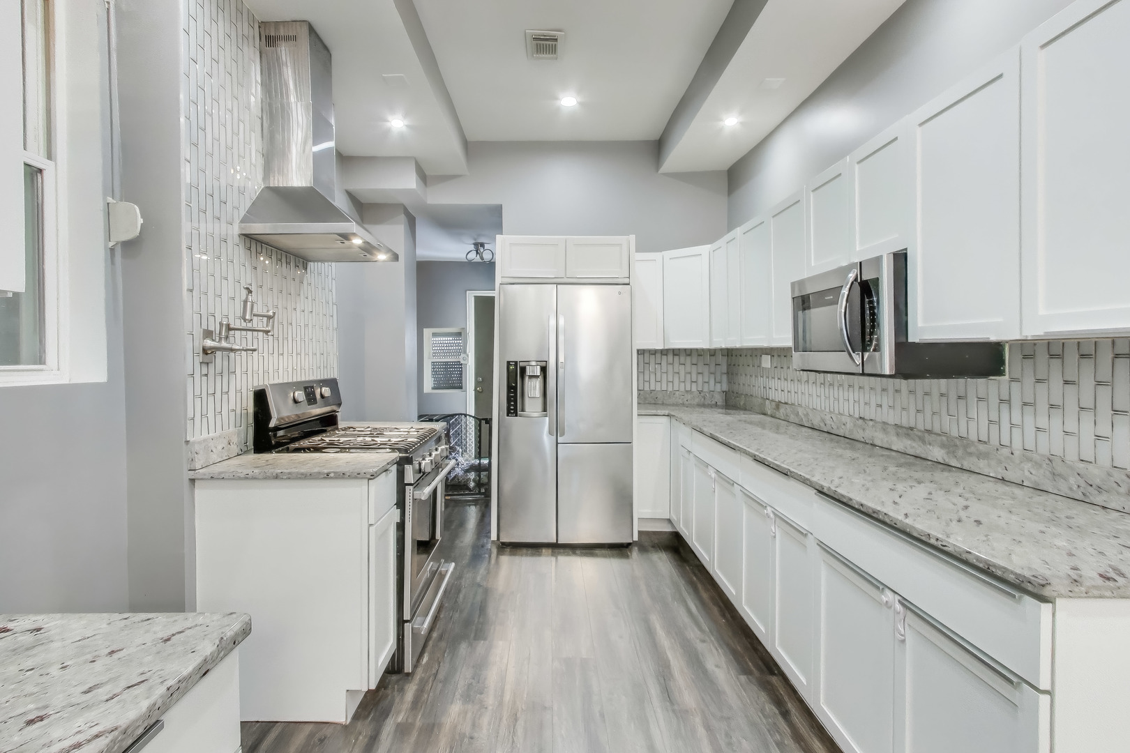 4049 South Indiana Avenue Chicago, IL 60653 - Photo 10 of 23 a kitchen with stainless steel appliances granite countertop a sink stove and refrigerator