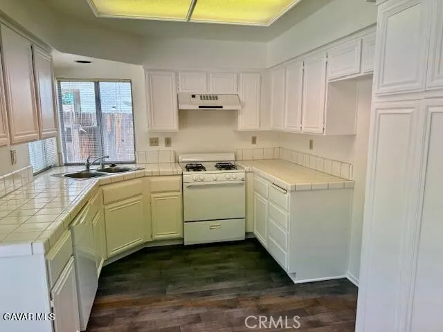 a utility room with cabinets washer and dryer