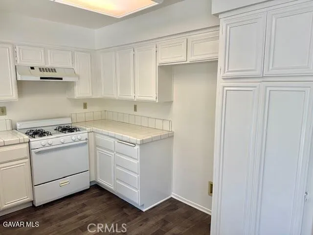 a view of a kitchen with electric appliances