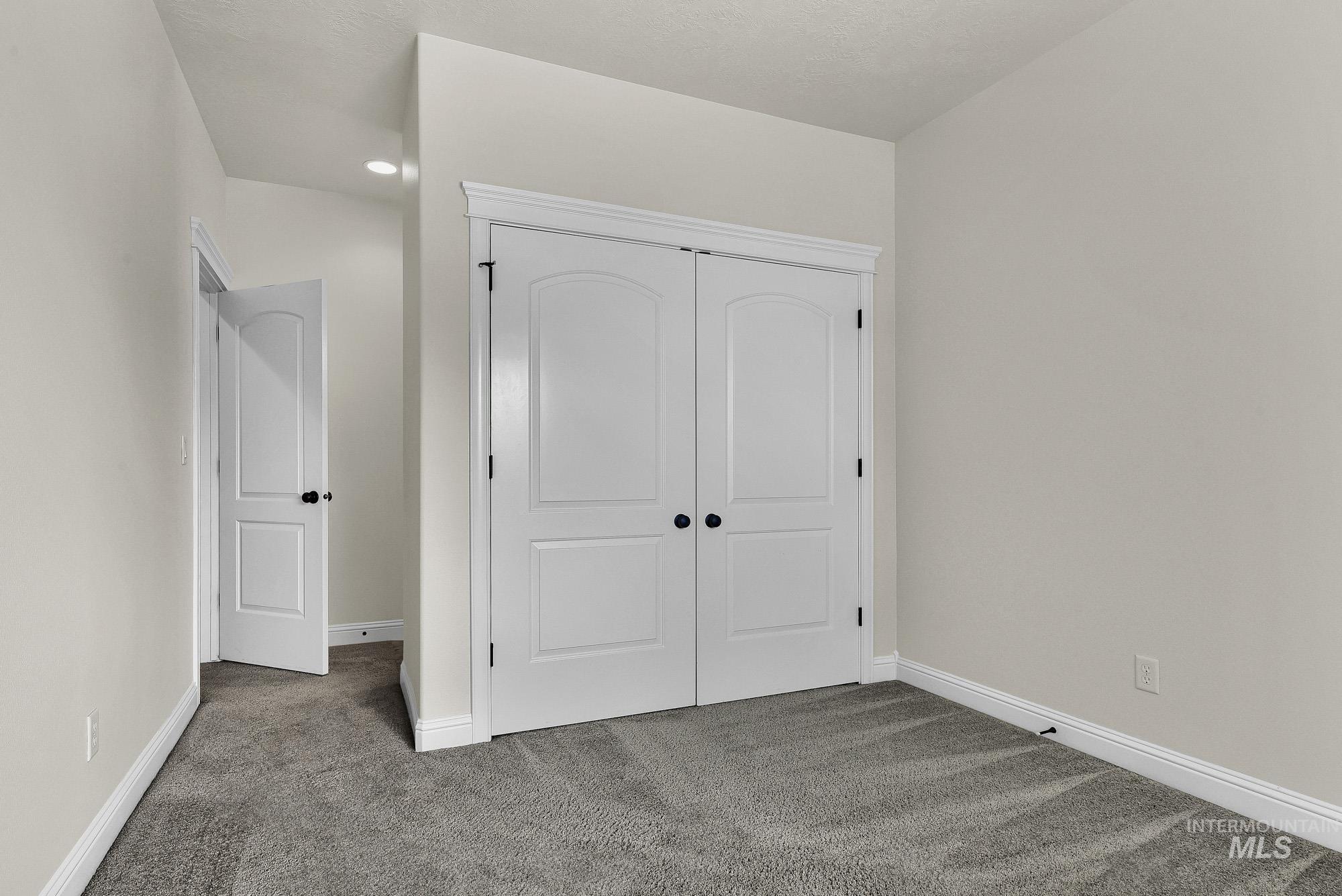 2172 West Cedar Grove Street Meridian, ID 83646 - Photo 24 of 49 Neutral-toned room with plush gray carpeting and white trim