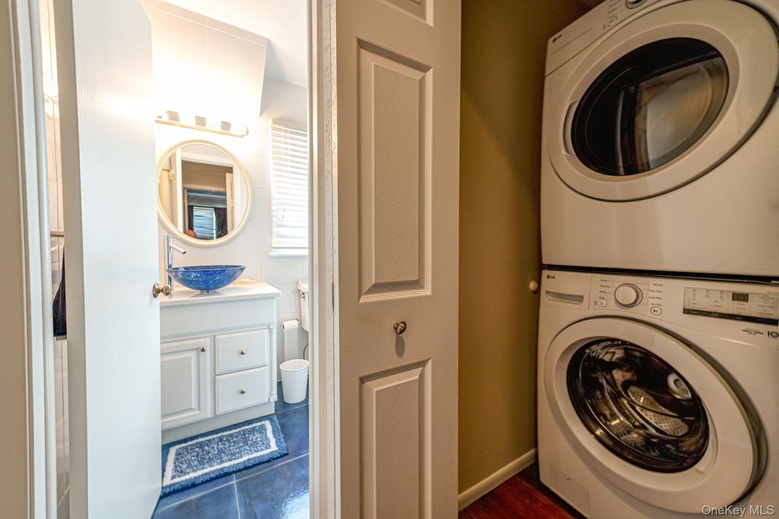 49 Canoe Place Road, Unit 212 Hampton Bays, NY 11946 - Photo 11 of 22 a utility room with dryer and washer
