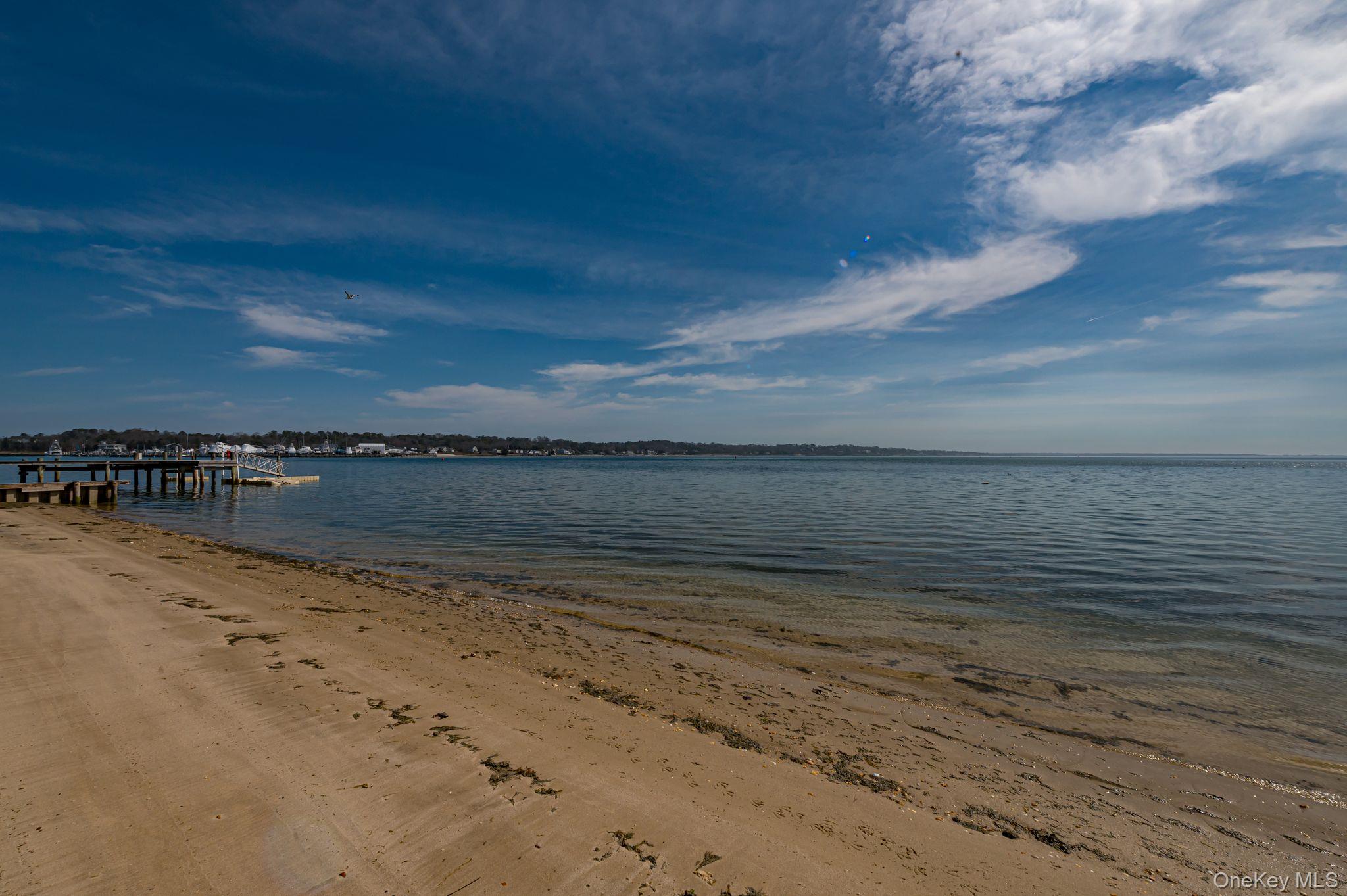 49 Canoe Place Road, Unit 212 Hampton Bays, NY 11946 - Photo 20 of 22 a view of an ocean beach