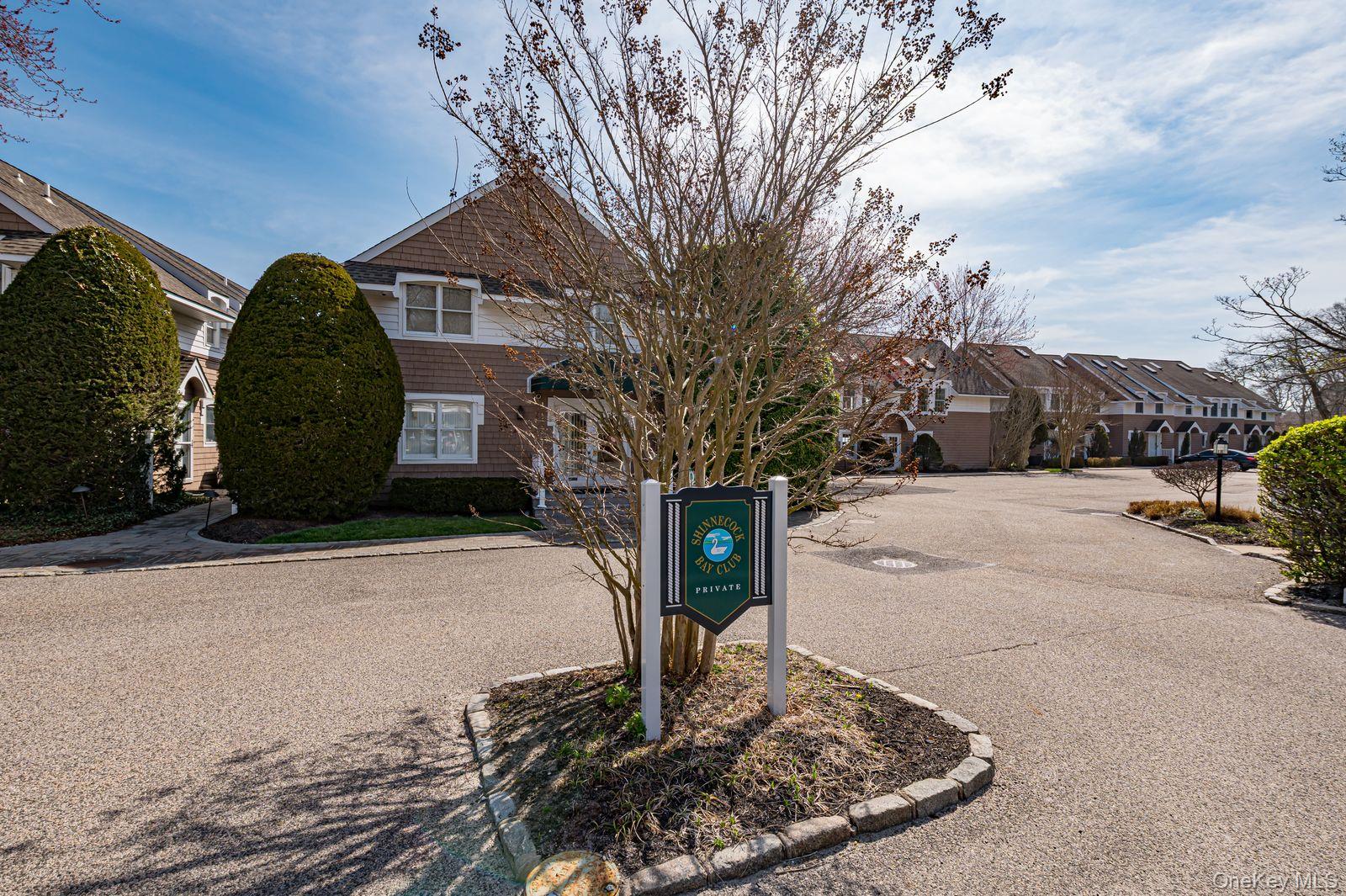 49 Canoe Place Road, Unit 212 Hampton Bays, NY 11946 - Photo 2 of 22 a front view of a house with garden